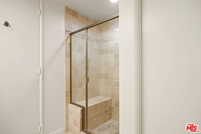 a bathroom with a glass shower door