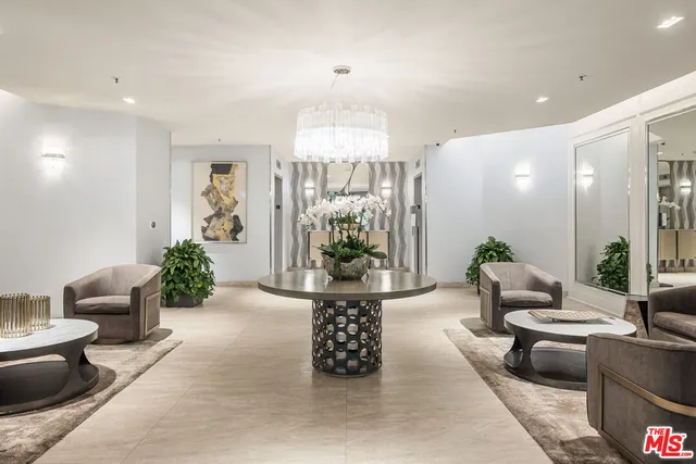 a living room with furniture and a chandelier