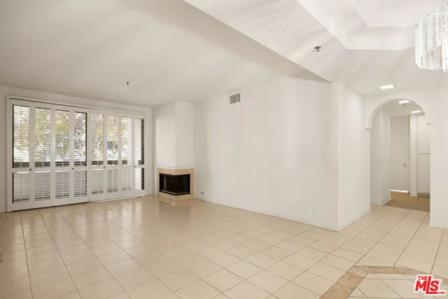 a view of an empty room with glass door