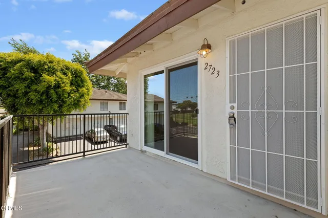 a view of a porch with wooden floor and fence