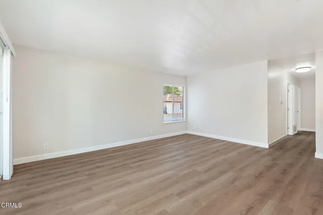 a view of a kitchen with wooden floor and electronic appliances