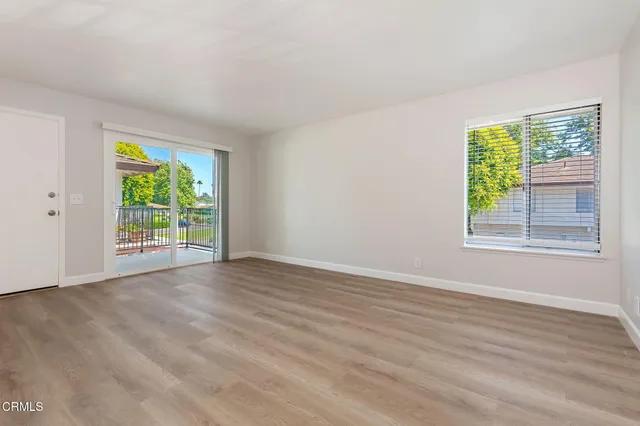 a view of kitchen with wooden floor and electronic appliances