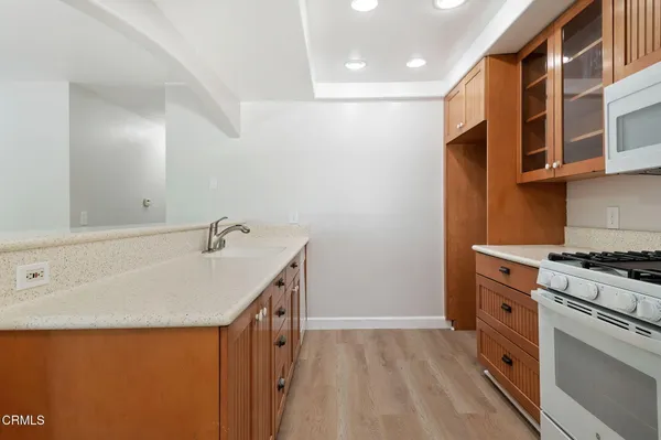 a spacious bathroom with a granite countertop sink and a mirror