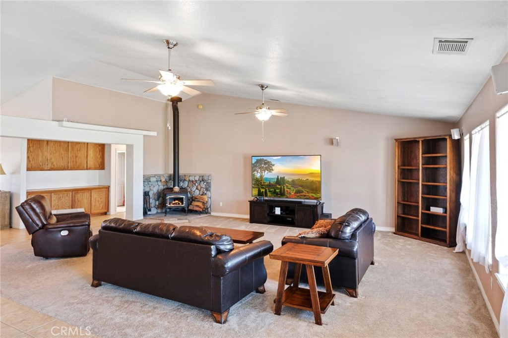 11025 El Esteban Road Phelan, CA 92371 - Photo 10 of 54 a living room with furniture and a flat screen tv