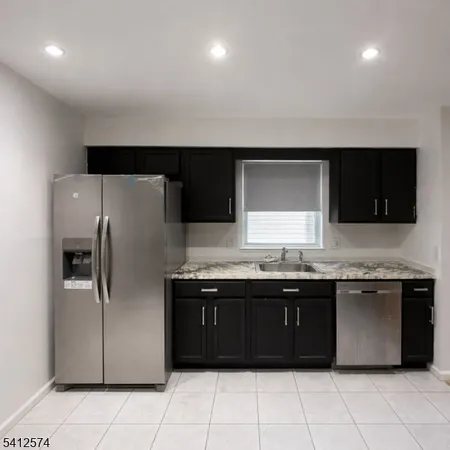 a kitchen with a sink and a refrigerator
