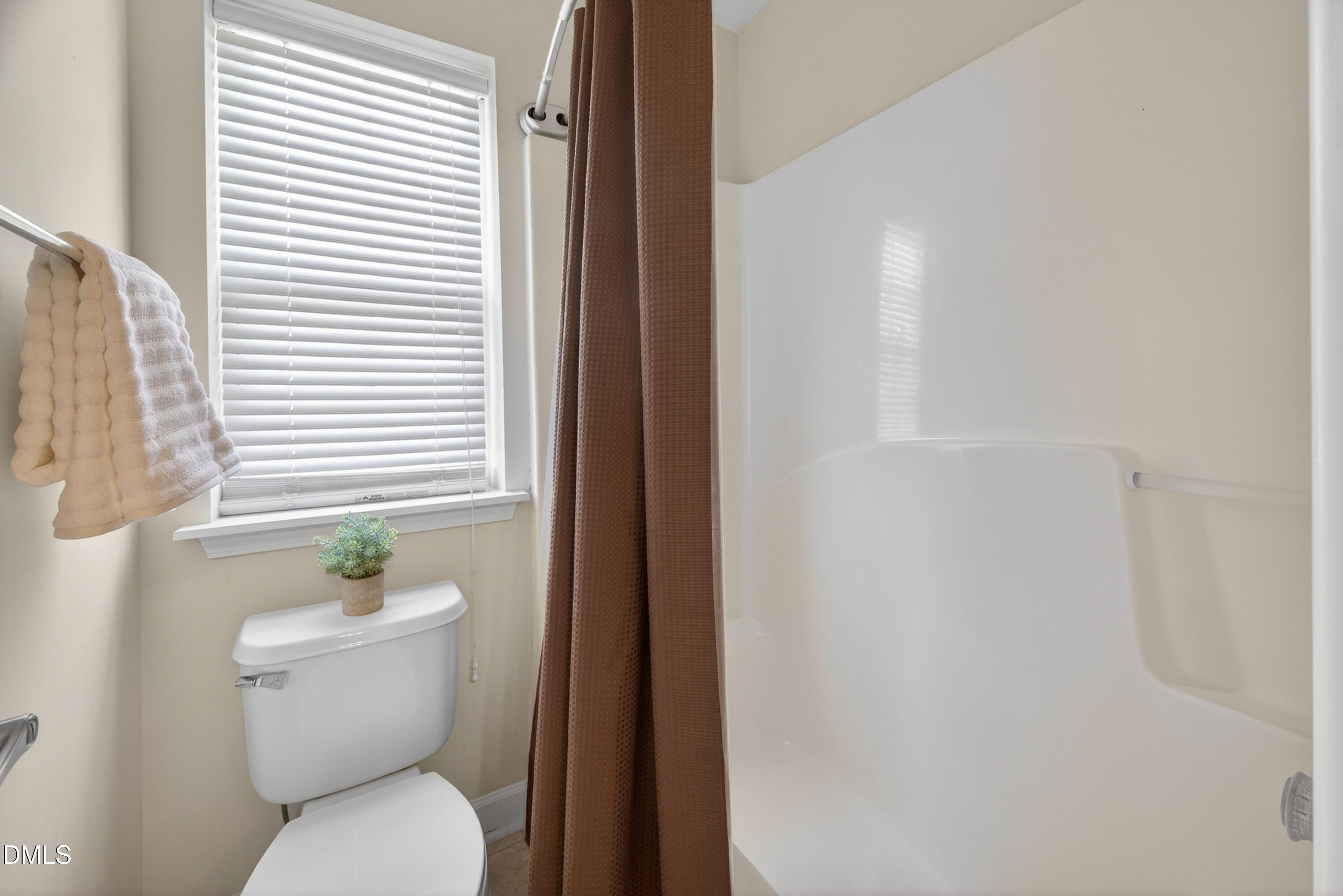 5304 Stone Station Drive Raleigh, NC 27616 - Photo 23 of 34 a white toilet sitting next to a bathroom sink