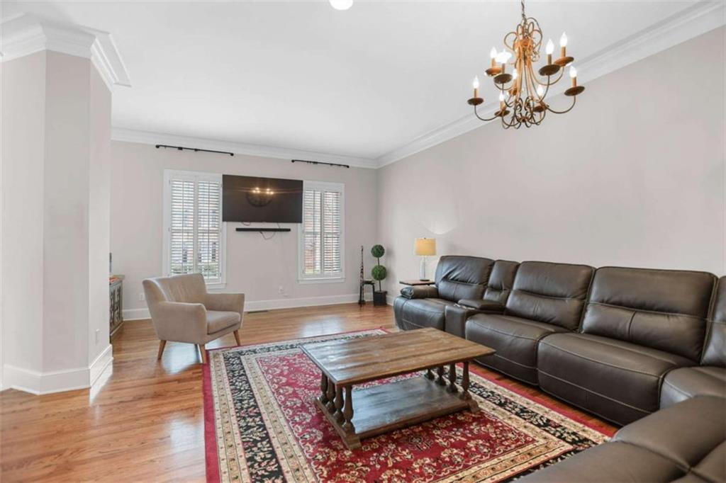 4712 Ivy Ridge Drive Southeast Atlanta, GA 30339 - Photo 14 of 82 a living room with furniture a wooden floor and a chandelier