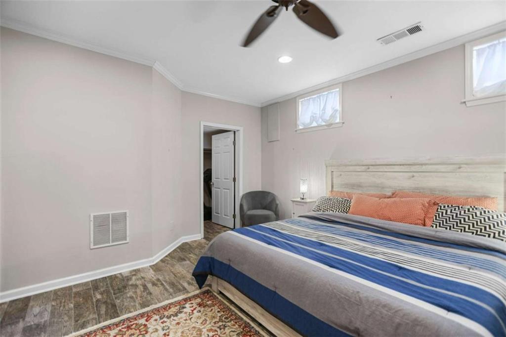 4712 Ivy Ridge Drive Southeast Atlanta, GA 30339 - Photo 28 of 82 a bedroom with a bed and a chandelier