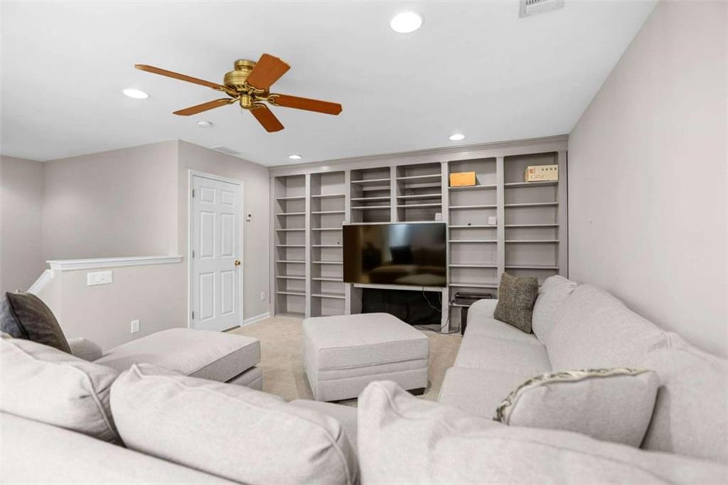 4712 Ivy Ridge Drive Southeast Atlanta, GA 30339 - Photo 48 of 82 a living room with furniture and a flat screen tv