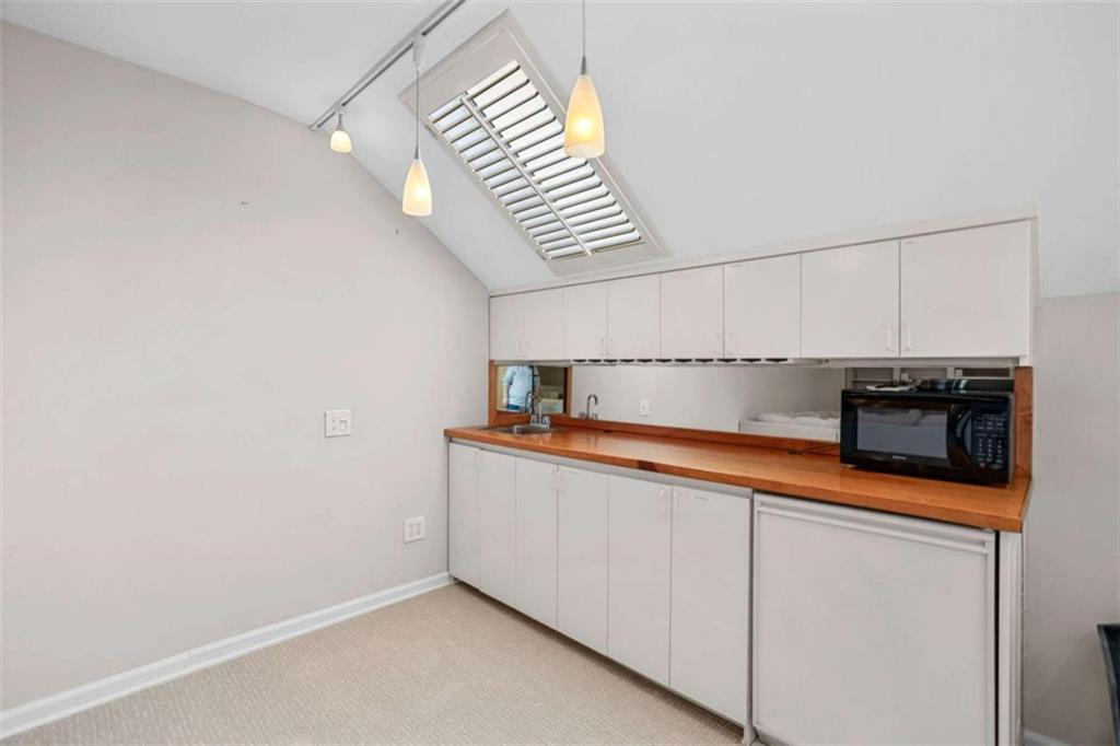 4712 Ivy Ridge Drive Southeast Atlanta, GA 30339 - Photo 49 of 82 a kitchen with stainless steel appliances a sink and a microwave