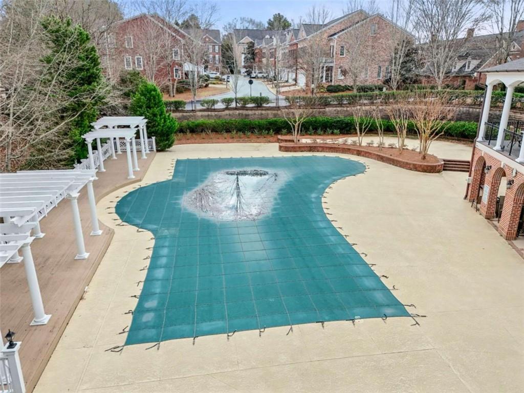 4712 Ivy Ridge Drive Southeast Atlanta, GA 30339 - Photo 67 of 82 a swimming pool with outdoor seating and yard