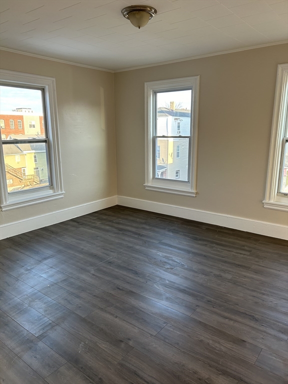 230 Pleasant Street, Unit 2 Worcester, MA 01609 - Photo 2 of 9 an empty room with wooden floor and windows