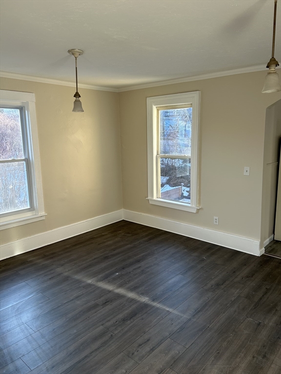 230 Pleasant Street, Unit 2 Worcester, MA 01609 - Photo 4 of 9 a view of an empty room with wooden floor and a window