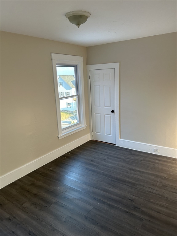 230 Pleasant Street, Unit 2 Worcester, MA 01609 - Photo 6 of 9 a view of an empty room with wooden floor and a window