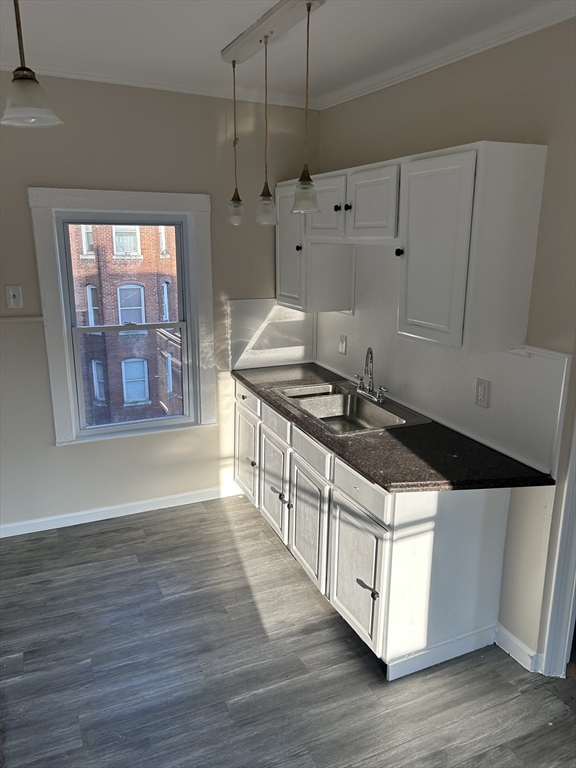 230 Pleasant Street, Unit 2 Worcester, MA 01609 - Photo 8 of 9 a kitchen with stainless steel appliances granite countertop a stove a sink and a microwave