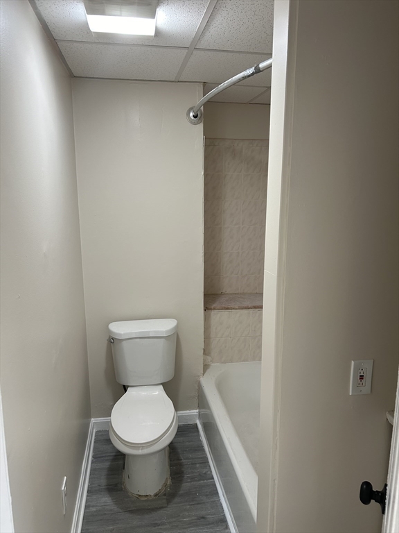 230 Pleasant Street, Unit 2 Worcester, MA 01609 - Photo 9 of 9 a white toilet sitting next to a bath tub