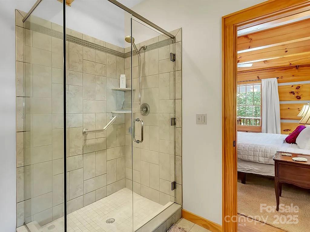 113 Mountain Cove Road Waynesville, NC 28786 - Photo 13 of 48 a bathroom with a glass door shower and a sink