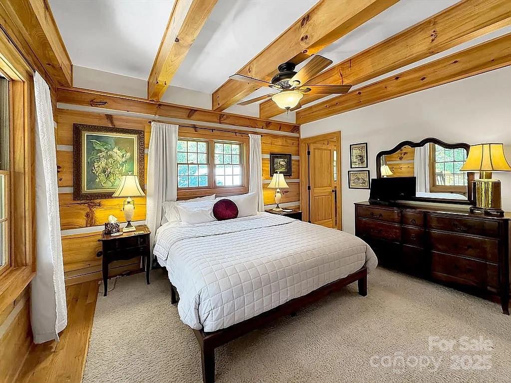 113 Mountain Cove Road Waynesville, NC 28786 - Photo 21 of 48 a spacious bedroom with a bed and wooden floor