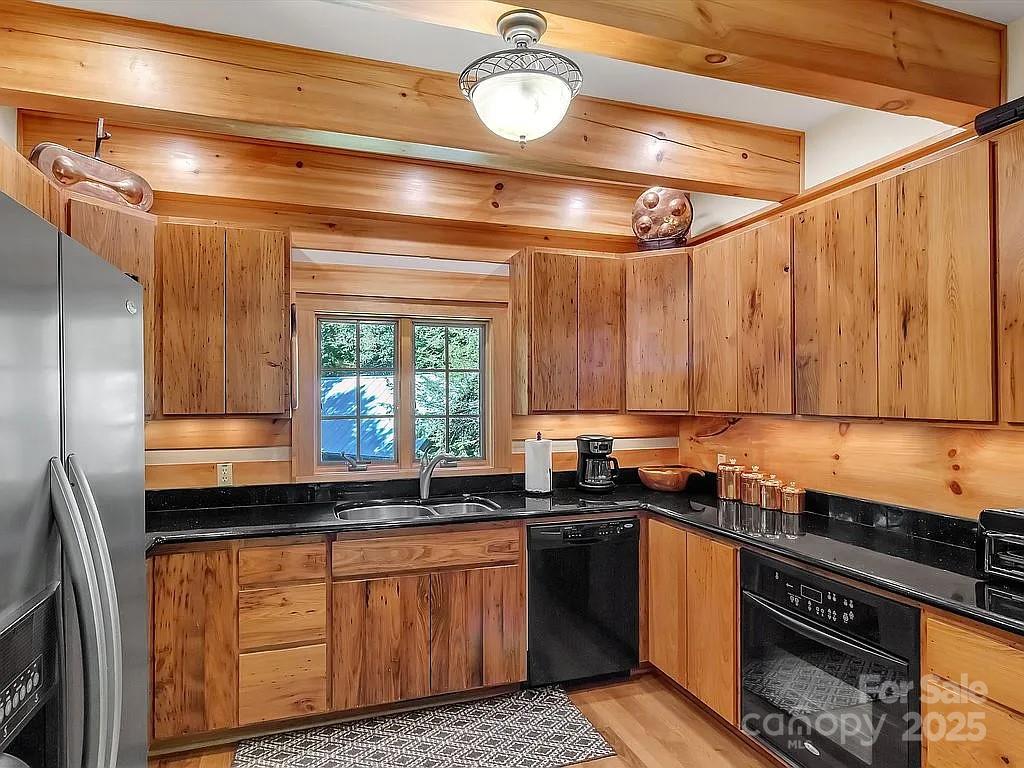113 Mountain Cove Road Waynesville, NC 28786 - Photo 24 of 48 a kitchen with a sink and a stove top oven