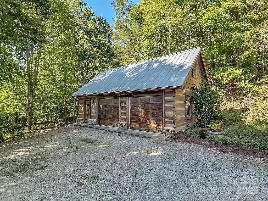 113 Mountain Cove Road Waynesville, NC 28786 - Photo 28 of 48 a view of a house with backyard and trees