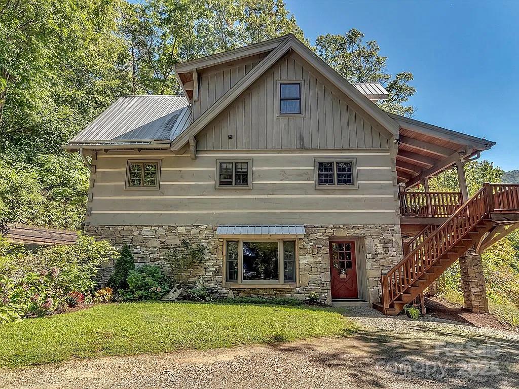 113 Mountain Cove Road Waynesville, NC 28786 - Photo 3 of 48 a front view of a house with a yard