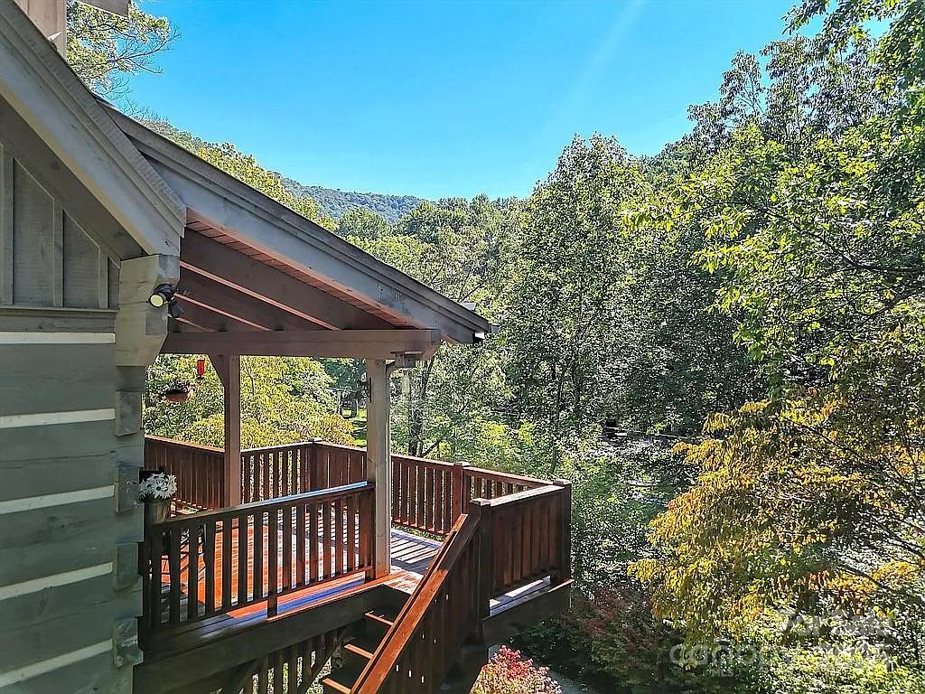 113 Mountain Cove Road Waynesville, NC 28786 - Photo 36 of 48 a balcony with wooden floor and outdoor space