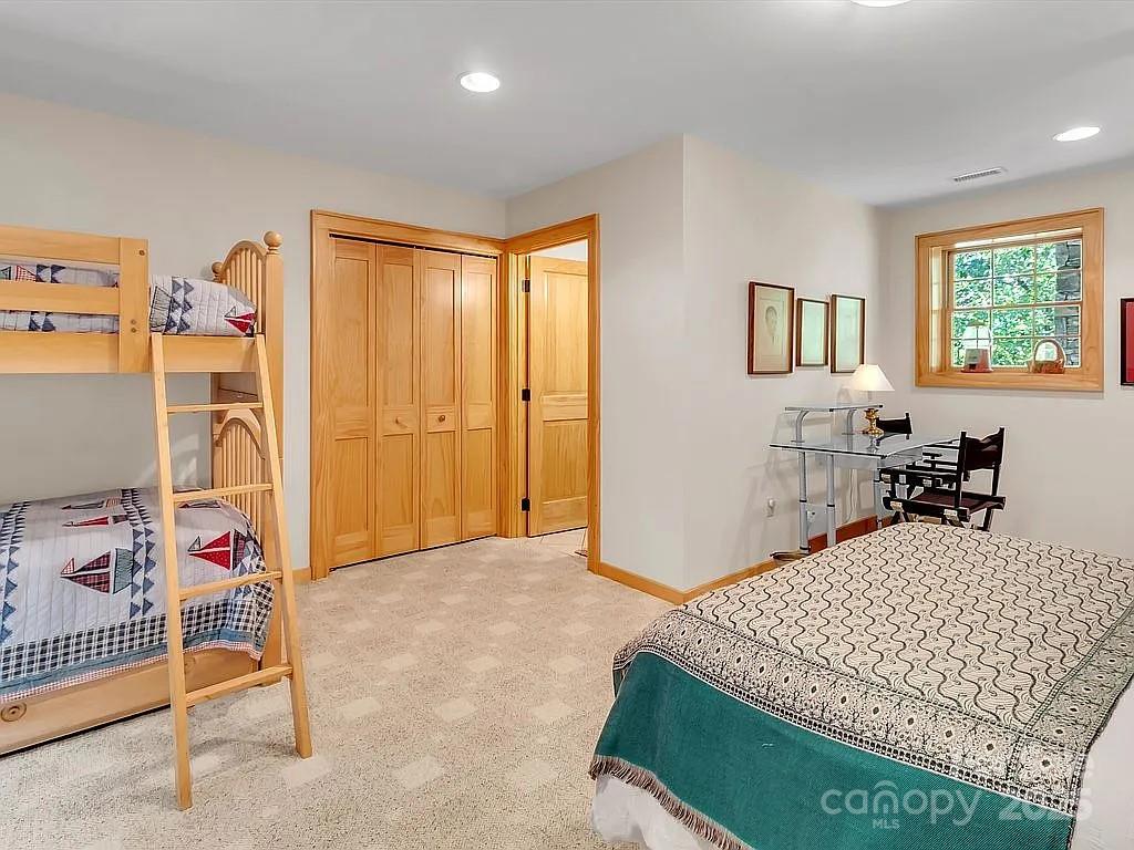 113 Mountain Cove Road Waynesville, NC 28786 - Photo 40 of 48 a bedroom with a bed and a window