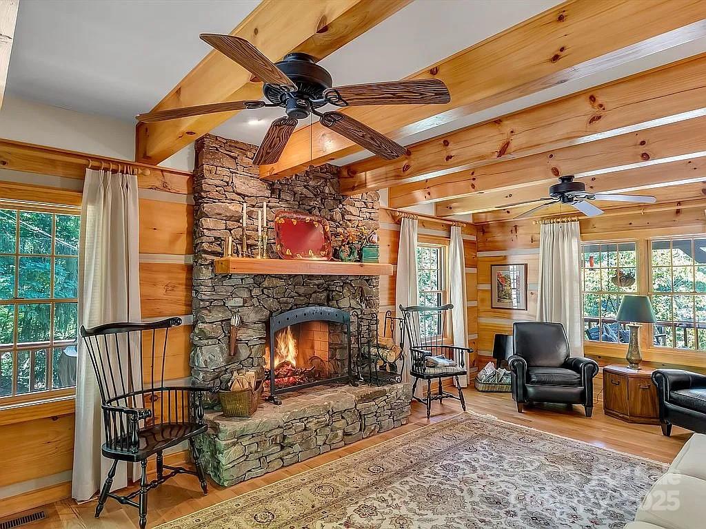 113 Mountain Cove Road Waynesville, NC 28786 - Photo 6 of 48 a living room with furniture a fireplace and a flat screen tv