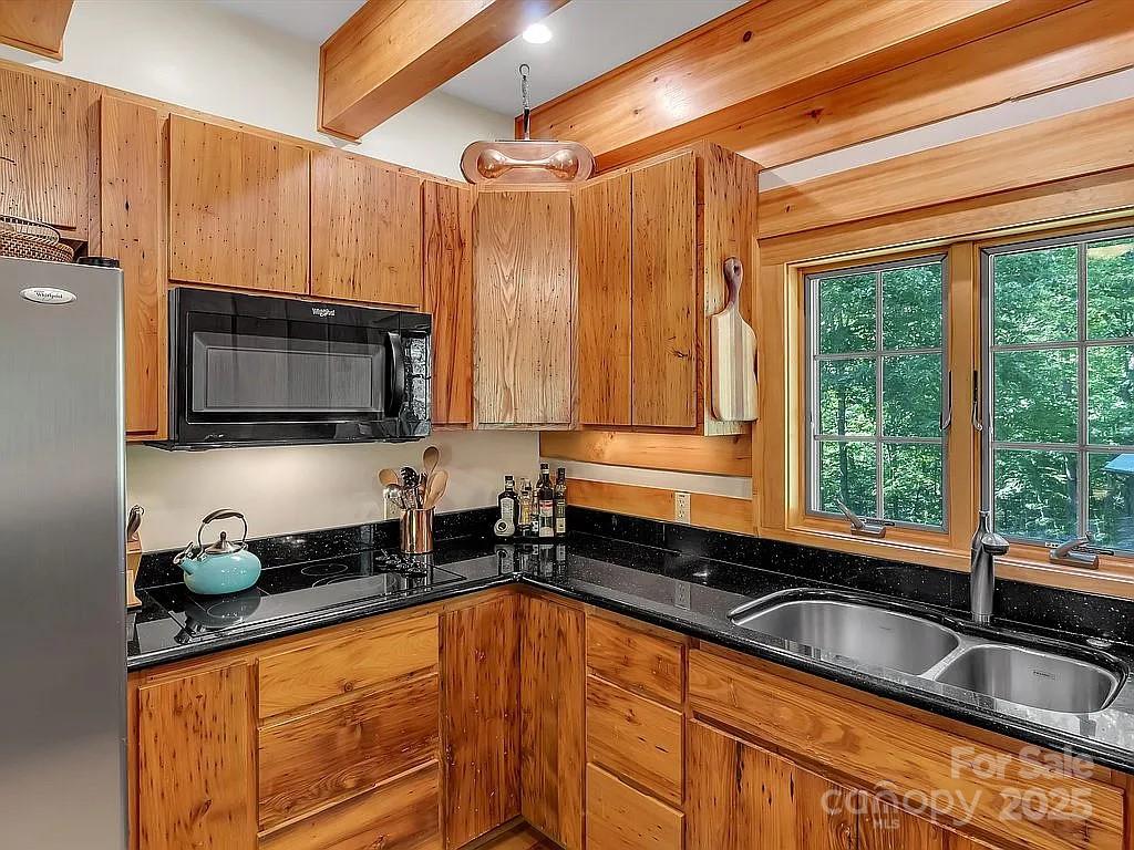 113 Mountain Cove Road Waynesville, NC 28786 - Photo 7 of 48 a kitchen with granite countertop a sink a counter top space and cabinets