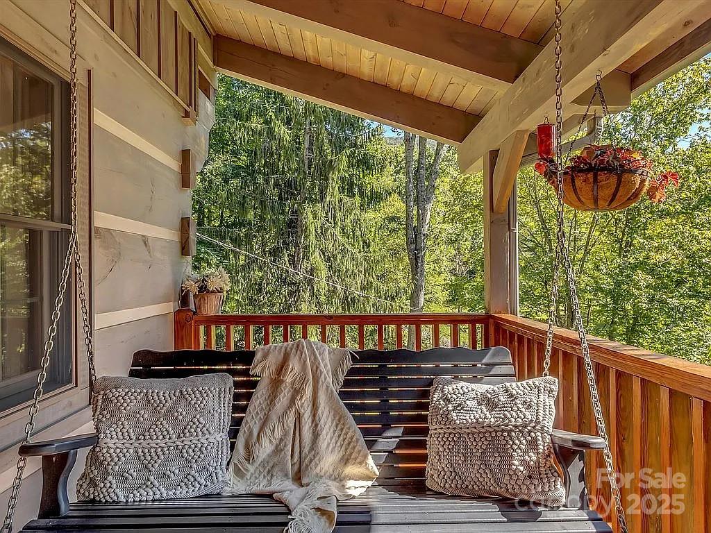 113 Mountain Cove Road Waynesville, NC 28786 - Photo 10 of 48 a view of balcony with wooden floor and outdoor seating