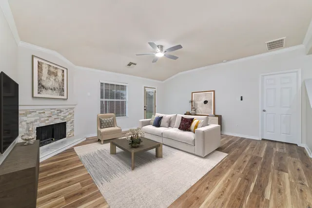 a living room with furniture and a fireplace