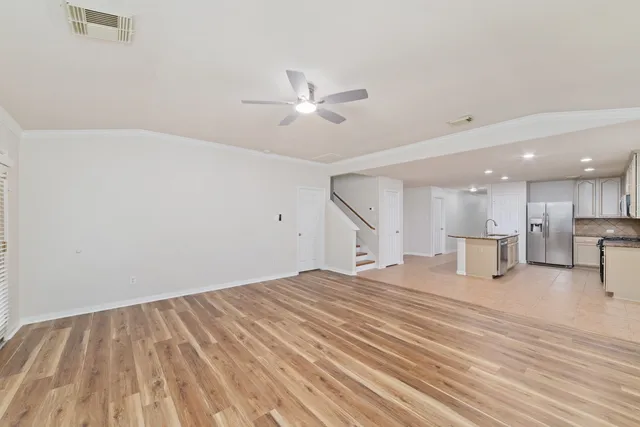 a view of empty room with wooden floor and fireplace
