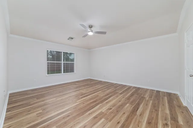 a spacious bedroom with a bed and a couch