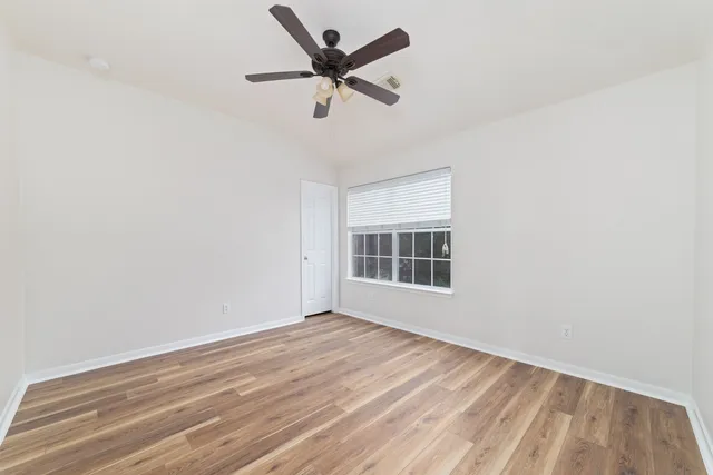 a bedroom with a bed and a potted plant