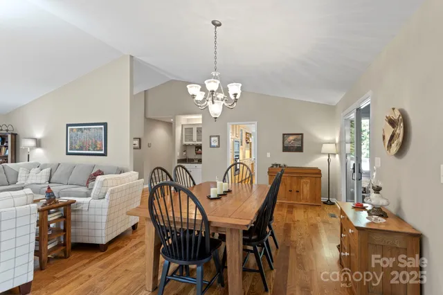 a view of a dining room with furniture and chandelier