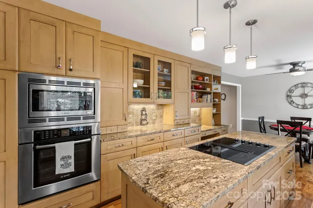 a kitchen with stainless steel appliances granite countertop a stove and a refrigerator
