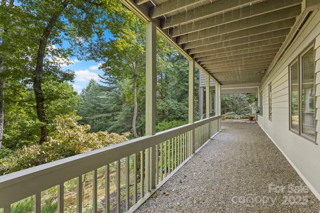 a view of a porch with wooden floor in front of house