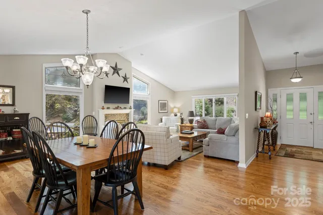 a view of a dining room with furniture wooden floor and chandelier