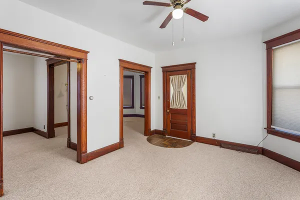 an empty room with windows and closet