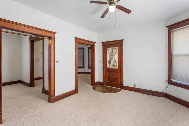 an empty room with windows and closet