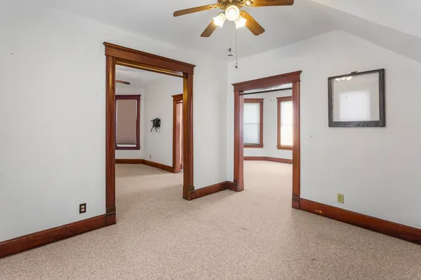 a view of a room with a ceiling fan