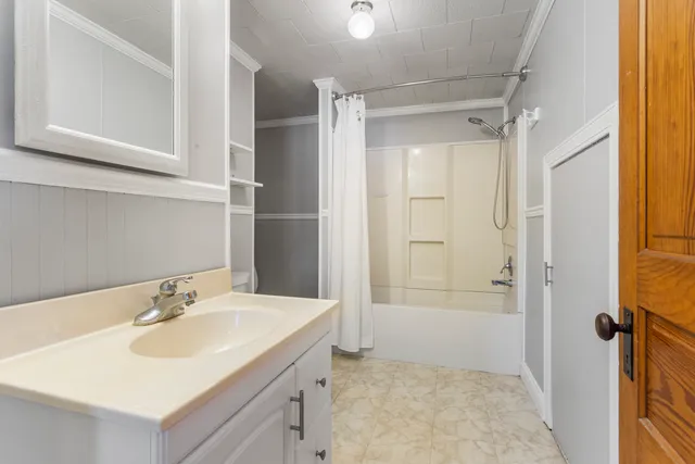 a bathroom with a sink and a mirror