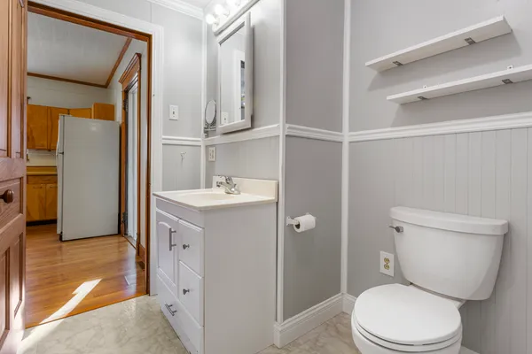 a bathroom with a toilet a sink and a tub