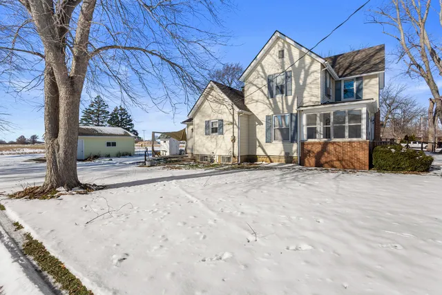 a view of a house with a snow in the yard