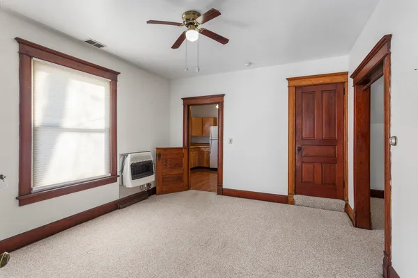a view of empty room with windows and fan