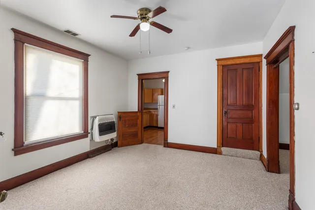 a view of empty room with windows and fan