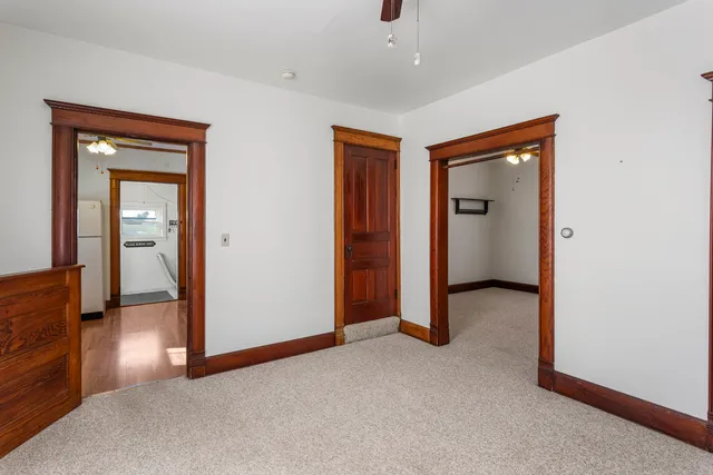 an empty room with closet and a bathroom