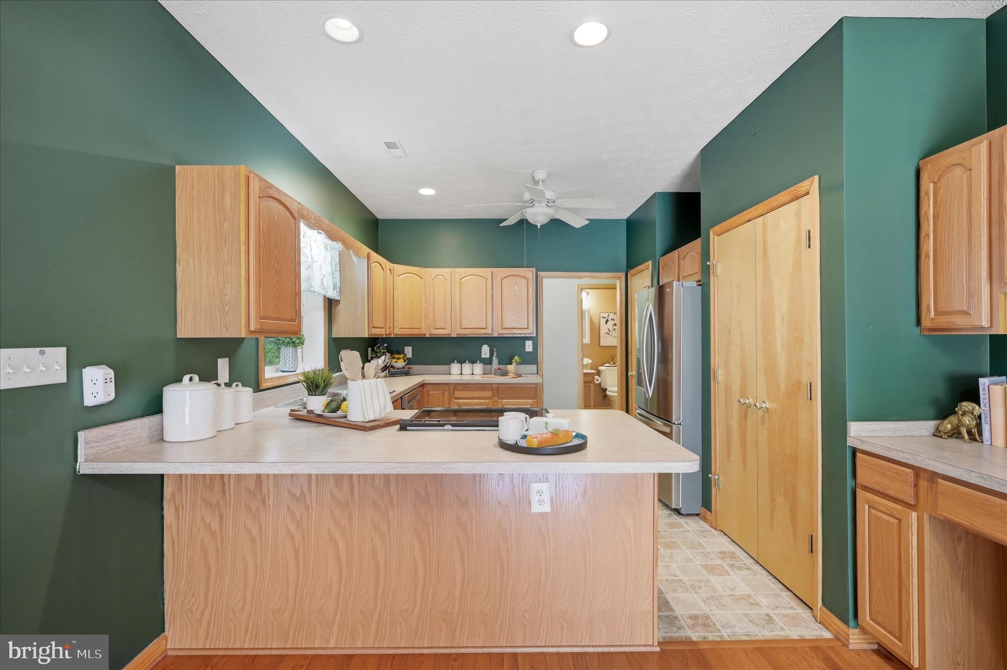 622 Co Rte 25/7 Charles Town, WV 25414 - Photo 12 of 54 a kitchen with a refrigerator a sink dishwasher with a dining table and chairs
