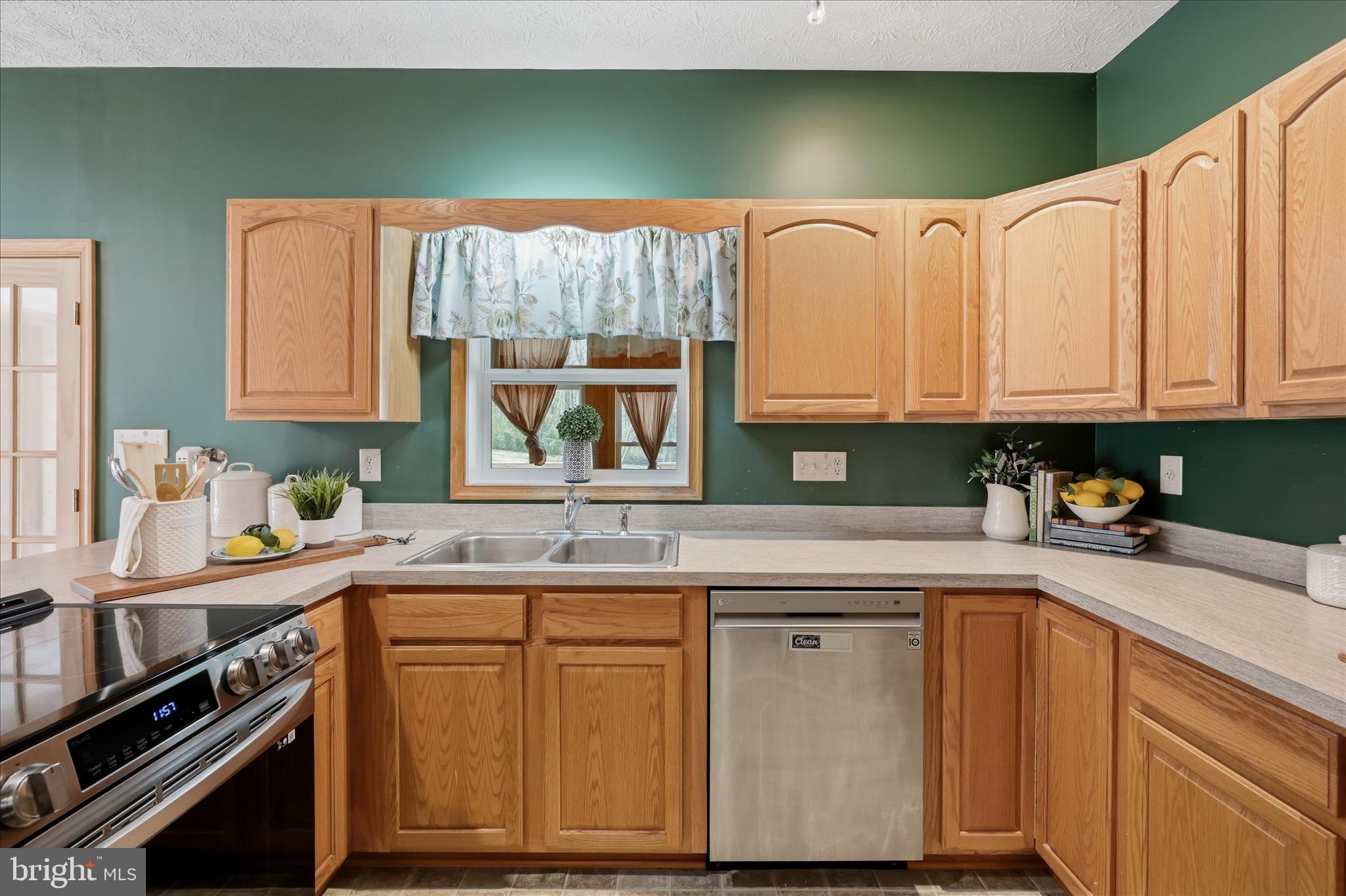 622 Co Rte 25/7 Charles Town, WV 25414 - Photo 14 of 54 a kitchen with stainless steel appliances granite countertop a sink and cabinets
