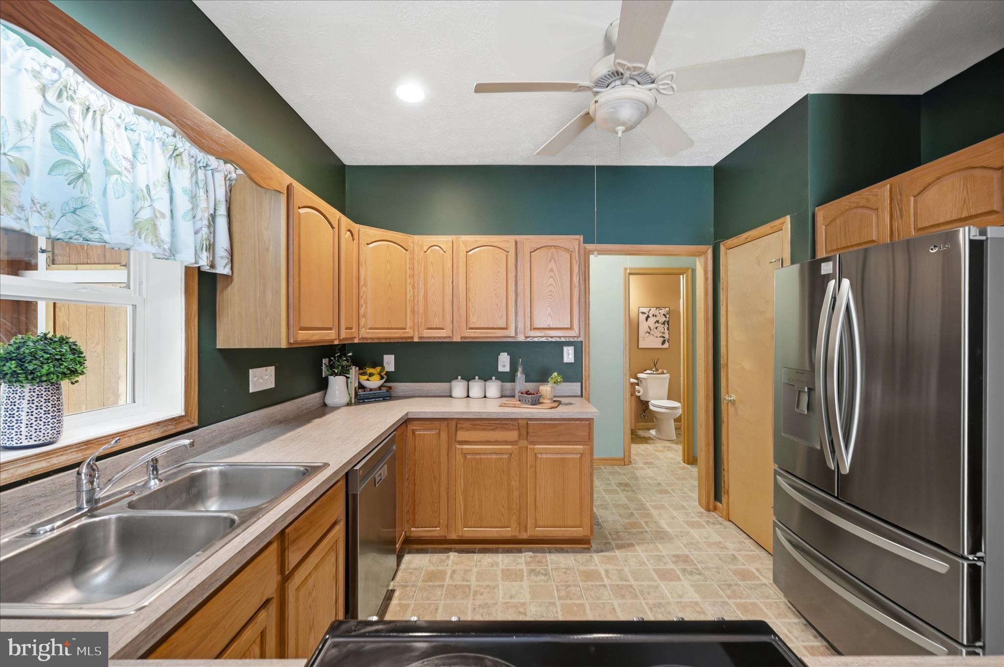 622 Co Rte 25/7 Charles Town, WV 25414 - Photo 15 of 54 a kitchen with stainless steel appliances granite countertop a sink refrigerator and cabinets